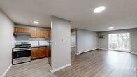 Located at 357 Newport Avenue in Quincy, MA, this one-bedroom, one-bathroom unit offers a well-organized single-floor layout with a clean, modern aesthetic throughout. Light-toned vinyl plank flooring runs seamlessly across every room, creating a cohesive and easy-to-maintain interior.

The living room is the largest space in the unit, featuring neutral gray walls, recessed and flush-mount ceiling lighting, a wall-mounted air conditioning unit, and a baseboard heating system. A sliding glass door fills the room with natural light and provides outdoor access. The open sightlines from the kitchen into the living area enhance the sense of space.

The kitchen is efficiently arranged in an L-shaped configuration, outfitted with warm honey-toned wood cabinetry, gray laminate countertops, a stainless steel refrigerator, a gas range with a range hood, and a double-basin sink. Recessed lighting illuminates the workspace effectively.

The bedroom is a comfortable, well-proportioned room with a double-door closet, baseboard heating, a window for natural light, and the same consistent flooring found throughout the unit.

The bathroom is finished in a clean, minimal style with white cabinetry, a white vanity, a full tub-shower combination with white tile surround, chrome fixtures, and wood-look flooring. The entrance provides a practical transition point into the main living areas.
