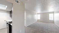 Located at 321 Directory Dr. in Columbus, OH, this single-floor, 2-bedroom, 1-bathroom unit offers a practical and well-organized layout. The living area is carpeted throughout and features a ceiling fan, neutral gray walls, and a textured ceiling, creating a clean and comfortable atmosphere. Large windows in key areas allow natural light to filter in, brightening the space.

The galley-style kitchen is a standout feature, equipped with dark shaker-style cabinetry, matte black hardware, light quartz countertops, a stainless steel sink with a matte black faucet, and a gas range. Light wood-look flooring completes the kitchen's modern aesthetic.

The generously sized primary bedroom offers ample space and is carpeted, with a textured ceiling and a window for natural light. The second bedroom is also carpeted and similarly finished. A dedicated closet with sliding doors and built-in rod provides useful storage.

The bathroom is clean and functional, featuring a full-size soaking tub/shower combo and wood-look flooring. A hallway connects the rooms efficiently, and HVAC vents are present throughout. This unit offers a straightforward, move-in-ready layout suited for comfortable everyday living.