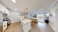 Located at 1776 E Second St in Scotch Plains, NJ, this well-appointed 2-bedroom, 2-bathroom residence offers a thoughtfully designed single-level layout. The open-concept kitchen and living area serves as the heart of the home, featuring white shaker cabinetry with matte black hardware, quartz countertops, stainless steel appliances, and a large central island with seating — all illuminated by stylish pendant lighting. Light hardwood flooring flows throughout, complementing the neutral warm-toned walls and crown molding details. The living area is bright and welcoming, with recessed lighting and a large sliding door that invites natural light and offers outdoor views. The spacious primary bedroom provides a comfortable retreat, while the second bedroom features a large window with outdoor views. Both bathrooms are finished with clean, modern fixtures; one includes a glass-enclosed walk-in shower with stone tile surround. Additional conveniences include three closets, an in-unit laundry room, and a utility room. The overall ambiance is clean, contemporary, and move-in ready, making this a well-rounded residence in a desirable New Jersey location.