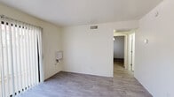 Located at 3985 N Stone Ave in Tucson, Arizona, this single-floor unit offers three bedrooms, one bathroom, a kitchen, and a connecting hallway. The interior is finished with light-toned luxury vinyl plank flooring throughout, providing a clean, cohesive look across all rooms.

The kitchen is laid out in a U-shape, featuring warm honey-toned wood cabinetry both above and below white laminate countertops, a double-basin sink, a white electric range, and a full-size refrigerator. A closet pantry and overhead lighting round out the functional space.

Each of the three bedrooms is finished with the same wood-look flooring and crisp white walls, creating a bright and neutral environment. The bedrooms vary slightly in size, with the primary bedroom offering a comfortable footprint. Windows in the bedrooms allow natural light to enter, with vertical blinds providing privacy. The rooms connect through a central hallway that links the living areas efficiently.

The bathroom includes a full tub-shower combination with white tile surround and chrome fixtures, maintaining the clean and practical aesthetic found throughout the unit.

Overall, the space presents a straightforward and functional layout with consistent finishes, making it a practical option for those seeking a multi-bedroom residence in the Tucson area.