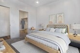 Located at 1327 S Main St in Spanish Fork, UT, this modern 1-bedroom, 1-bathroom apartment offers 690 square feet of efficient, well-appointed living space on a single floor. The open-concept kitchen and living area features durable wood-look LVP flooring, recessed lighting, and a sliding glass door that opens to a private balcony with scenic outdoor views of surrounding trees and mountains. The kitchen is equipped with stainless steel appliances including a range, microwave, and refrigerator, complemented by contemporary taupe cabinetry, light countertops, and a central island with a sink. The living area is bright and airy, filled with natural light from the large sliding door. The 170-square-foot bedroom features plush carpet, recessed lighting, and a window with mountain views, providing a comfortable retreat. An adjacent dedicated closet offers a hanging rod and built-in shelf for organized storage. The bathroom includes a full tub and shower combo, a wood-toned vanity with a white countertop, and open built-in shelving for added convenience. Clean white walls and modern finishes throughout give this apartment a fresh, contemporary feel.