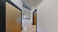 Located at 202 North 20th Street in Richmond, Virginia, this two-bedroom, two-bathroom residence offers a thoughtfully designed single-floor layout that blends industrial character with modern comfort. Light hardwood flooring flows throughout the main living areas, complemented by crisp white walls and bold dark baseboards and door trim that give the space a clean, contemporary edge.

The kitchen is a standout feature, showcasing dark espresso cabinetry, stainless steel appliances, granite countertops, and a central island that provides additional prep space and seating. Exposed ductwork overhead adds an industrial loft aesthetic that carries into the main corridor and living areas.

The spacious primary bedroom benefits from a ceiling fan, natural light from exterior-facing windows, and access to a patio — ideal for indoor-outdoor living. The second bedroom is equally well-proportioned with the same warm hardwood flooring and clean finishes. A dedicated closet provides convenient storage.

Both bathrooms are finished with large-format gray tile flooring and tub-shower combinations. One features elegant mosaic tile detailing, while the other includes accessibility-friendly grab bars and a granite-topped vanity. A private patio rounds out this well-appointed residence, offering outdoor space in the heart of Richmond.