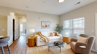 Located at 5164 Central College Rd. in Westerville, Ohio, this single-floor, 2-bedroom, 2-bathroom residence offers a thoughtfully designed layout with modern finishes throughout. The open-concept living and kitchen area serves as the heart of the home, where warm wood-look flooring, neutral tones, and large windows with slatted blinds create a bright and welcoming atmosphere. A patio door in the living area provides direct outdoor access, enhancing the sense of space and natural light.

The kitchen is outfitted with sleek gray cabinetry, white countertops, and a full suite of stainless steel appliances, including a refrigerator, range, microwave, and dishwasher. Wood-look flooring extends throughout the kitchen for a cohesive aesthetic.

Both bedrooms are carpeted and well-proportioned, with the primary bedroom offering a generous footprint, large windows with outdoor views, and ample closet storage. The second bedroom connects conveniently to the rest of the unit through a central hallway.

Each bathroom features wood-look flooring, a modern vanity with white countertop and a dark-framed mirror, and either a soaking tub or glass-enclosed shower. A dedicated laundry area and utility room add practical everyday convenience to this well-rounded home.