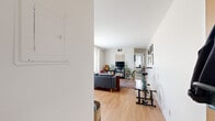 Located at 2952–2998 W 50th St in Minneapolis, MN, this one-bedroom, one-bathroom unit offers a well-organized layout across a single floor. The living room is the heart of the space, featuring warm hardwood flooring and large windows dressed with sheer curtains that allow abundant natural light to fill the room. The open flow from the entryway into the living area provides a sense of spaciousness despite the compact footprint. The kitchen includes white cabinetry with glass-front uppers, a dishwasher, tile flooring, and a casual dining nook with a wooden bar-height table and stools — a practical setup for everyday living. The bedroom offers carpeted flooring, crown molding, a ceiling fan, and a window that brings in soft natural light, creating a calm and restful atmosphere. The bathroom features classic white tile walls, mosaic tile flooring, a pedestal sink, a mirrored medicine cabinet, and a shower-tub combination. Throughout the unit, clean white walls and consistent finishes provide a neutral backdrop. The layout efficiently accommodates a living area, dedicated workspace, and entryway, making the most of every square foot in this functional Minneapolis residence.