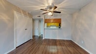 Located at 210 E Wintergreen Rd in DeSoto, TX, this single-floor 1-bedroom unit offers a practical and comfortable layout designed for everyday living. The living area is bright and open, featuring rich wood-style flooring, a textured ceiling, and a ceiling fan with integrated lighting. A generously sized closet provides ample storage, while a pass-through counter connects the living space to the kitchen, enhancing the sense of openness. A sliding glass door floods the room with natural light and opens to a private balcony with outdoor views.

The galley-style kitchen is efficiently designed with warm honey-toned wood cabinetry lining both walls, speckled countertops, a stainless steel sink, and black appliances including a range, over-the-range microwave, and refrigerator. The layout maximizes counter and storage space throughout.

The bedroom is a quiet retreat with wood-style flooring, neutral walls, and a window fitted with blinds that allow for adjustable natural light. The bathroom includes a combined tub and shower, a wood-framed vanity mirror, and tile-style flooring, offering a clean and functional space. Overall, the unit presents a cohesive, low-maintenance interior suitable for comfortable residential living.