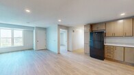 Located at 2945 Garfield Ave in Minneapolis, MN, this well-appointed unit offers four bedrooms, two bathrooms, and a combined kitchen and living area across a single floor. Light wood-style flooring flows consistently throughout the space, lending a clean and cohesive aesthetic.

The kitchen is a functional standout, featuring light maple cabinetry that extends to the ceiling for ample storage, white countertops, and a full suite of black appliances including a refrigerator, range, microwave, and dishwasher. Recessed lighting illuminates the kitchen, which opens directly into the living area for easy entertaining.

Each of the four bedrooms is finished with the same light flooring and neutral wall tones, creating a calm and versatile environment. Several bedrooms feature large windows that invite abundant natural light and offer views of the surrounding neighborhood and greenery. The primary bedroom provides a comfortable, well-sized retreat.

Both bathrooms are finished with large-format tile flooring, warm wood vanity cabinetry with black hardware, white countertops, and full tub-shower combinations with white tile surrounds. Large mirrors above the vanities add brightness and depth to each bathroom. The overall design is modern, clean, and move-in ready.