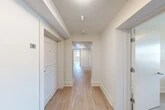 Located in Syracuse, NY, this thoughtfully designed 4-bedroom, 3-bathroom home offers a clean, modern aesthetic throughout its single-floor layout. Light wood flooring runs continuously through the hallways and living areas, complementing the bright, neutral color palette that gives the entire space an open and airy feel.

The kitchen is well-appointed with white shaker-style cabinetry, stainless steel appliances including a range, microwave, dishwasher, and refrigerator, and light countertops. An adjacent open area provides flexible use as a dining or living space, with a window that brings in natural light.

The living room offers a comfortable, versatile space, while two connecting hallways provide efficient circulation throughout the home. Each of the four bedrooms features light wood flooring, neutral walls, and dedicated closet space, creating calm, functional retreats. The spacious primary bedroom is notably generous in size and includes its own closet.

The three bathrooms are finished in a clean, minimalist style with white surrounds, light tile flooring, and modern fixtures. One bathroom features plantation shutters allowing for natural light and privacy. Throughout the home, recessed lighting and flush-mount ceiling fixtures ensure consistent, well-distributed illumination. This home is well-suited for shared living, offering both private and communal spaces in a cohesive, move-in-ready package.