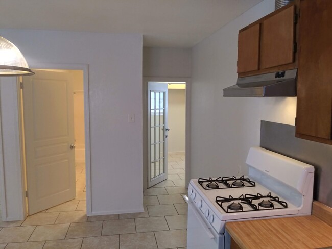 Kitchen looking into the storage room and bathroom - 403 Ellana Claire St