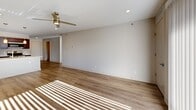 Located at 4781 Transit Rd in Depew, NY, this thoughtfully designed one-bedroom, one-bathroom residence offers a comfortable and modern living experience across a single floor. Light wood-style flooring runs consistently throughout, creating a cohesive and clean aesthetic in every room.

The open-concept living room and kitchen area forms the heart of the space. The living room is bright and airy, benefiting from natural light streaming through a sliding glass door and fitted with a ceiling fan with integrated lighting. The kitchen is well-equipped with rich dark-espresso cabinetry, stainless steel appliances including a refrigerator, range, and microwave, and a generous island featuring a built-in sink, light stone countertops, and stylish pendant lighting overhead.

The spacious primary bedroom receives abundant natural light through a large window and offers a comfortable, versatile layout. Two closets provide ample storage, including a walk-in closet outfitted with wire shelving systems for organized storage.

The bathroom is clean and functional, featuring a glass-enclosed shower, wood-look flooring, and brushed nickel hardware accents. A utility room completes the layout, adding practical everyday convenience. Neutral wall tones throughout lend the space a calm, move-in-ready atmosphere.