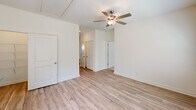 Located at 3164 Mulberry Blvd in Port Wentworth, Georgia, this well-designed single-story home offers 2 bedrooms and 2 bathrooms with a thoughtful, efficient layout. The open-concept living and kitchen area serves as the heart of the home, featuring light wood-look flooring, a ceiling fan, and a sliding glass door that fills the space with natural light. The kitchen is a standout, boasting white shaker cabinetry, a gray subway tile backsplash, granite countertops, a large center island with an undermount sink and breakfast bar seating, pendant lighting, and a full suite of stainless steel appliances. A hallway connects the living area to the private quarters. Both bedrooms are comfortably sized, carpeted, and equipped with ceiling fans and windows with blinds that allow for ample natural light. The primary bedroom is generously proportioned and accesses a well-appointed en-suite bathroom featuring a double-sink vanity with granite countertops, wood-look flooring, a separate shower, and a window for natural ventilation. The second bathroom includes a single-sink granite vanity and a tub-shower combination. Each bedroom includes a dedicated closet. The home's clean, neutral palette and modern finishes create a bright, welcoming atmosphere throughout.