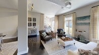 Located in the heart of Buckhead at 3400 Stratford Rd NE, Atlanta, this 2-bedroom, 2-bathroom loft-style residence offers a thoughtfully designed single-floor layout with distinct industrial-modern character. Polished concrete floors and exposed cylindrical ductwork run throughout, lending an urban loft aesthetic that is both striking and cohesive.

The open-concept living, dining, and kitchen area forms the heart of the home. The kitchen is outfitted with rich dark-espresso cabinetry, subway tile backsplash, granite countertops, and a full suite of stainless steel appliances. The dining area flows seamlessly into a spacious living room bathed in natural light from large floor-to-ceiling windows and French doors that open directly onto a private balcony with outdoor views of lush greenery.

The primary bedroom is generously sized, featuring large windows and balcony access, filling the room with abundant natural light. Both bathrooms are finished with granite-topped vanities, wood-framed mirrors, and white cabinetry. The secondary bathroom includes a full soaking tub and shower combination. Additional highlights include four closets, a dedicated utility room, and ceiling fans in the bedrooms. The result is a well-appointed, light-filled residence that balances urban industrial design with comfortable, functional living.