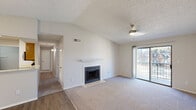 Located at 222 Kyser Blvd in Madison, Alabama, this single-floor residence offers a thoughtfully designed layout with a variety of functional and comfortable living spaces. The open living area immediately impresses with vaulted ceilings, a ceiling fan with integrated lighting, and a wood-burning fireplace framed by a classic white mantel and tile hearth. Sliding glass doors lead to a private balcony, allowing natural light to fill the room. Flooring throughout transitions between durable wood-look vinyl and plush carpet, providing both practicality and warmth. The dining area features hardwood-style flooring, an elegant chandelier, and a full-wall mirror that amplifies the sense of space. The galley-style kitchen is well-appointed with warm wood cabinetry, light countertops, and stainless steel appliances including a refrigerator, electric range, and over-the-range microwave. The bedrooms are generously proportioned, each with plush carpeting, ceiling fans, and ample closet space. The bathroom is clean and functional, featuring a tiled tub-shower combination and wood-look vinyl flooring. Textured ceilings are consistent throughout the home, and neutral wall tones create a versatile, move-in-ready environment throughout this well-maintained Madison residence.