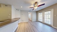 This 420 square foot apartment in Nashville, TN, offers a well-designed living space that maximizes functionality. The single-floor layout comprises one bedroom, measuring 120 square feet, one bathroom, a kitchen, and a living area. The open-concept design creates a sense of spaciousness, with light wood-look flooring throughout enhancing visual continuity.

The kitchen features light wood cabinetry, black appliances including a refrigerator, stove, and over-the-range microwave. A double sink and ample counter space, including a peninsula that doubles as a breakfast bar, make meal preparation convenient.

The bedroom, while compact, includes a ceiling fan and a large window with blinds, allowing for natural light and airflow. The bathroom is efficiently designed with a standard tub-shower combination, toilet, and simple fixtures.

French doors in the main living area lead to an outdoor space, providing additional natural light and a connection to the exterior. Modern touches like contemporary light fixtures and neutral wall colors contribute to the apartment's fresh, updated feel. Despite its modest size, this apartment offers a comfortable living environment with all essential amenities.