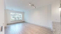 This well-appointed one-bedroom, one-bathroom residence at 30 Shattuck Rd in Andover, Massachusetts offers a thoughtfully designed single-floor layout with modern finishes throughout. The open-concept living area is bright and welcoming, featuring light wood-style flooring, crisp white walls, and large windows that invite generous natural light and outdoor views. Track lighting and a clean architectural aesthetic give the space a contemporary feel.

The kitchen is a standout feature, equipped with dark espresso cabinetry, granite countertops, a tiled backsplash, stainless steel appliances — including a refrigerator, range, microwave, and dishwasher — and a peninsula with pendant lighting that seamlessly connects the kitchen to the living area. A private balcony provides an outdoor retreat, accessible directly from the living space.

The bedroom offers a comfortable footprint with carpet flooring, a bright window, and direct access to a spacious walk-in closet with built-in wire shelving for ample storage. A second closet provides additional organizational space, along with a dedicated utility room.

The bathroom features tile flooring, a granite-topped dark vanity, a wall-mounted cabinet, and a full soaking tub with marble-surround shower. An in-unit laundry area adds everyday convenience to this well-rounded residence.