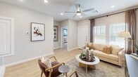 Located at 9004 Apple Orchard Ln in Fort Worth, TX, this two-story home offers a thoughtfully designed layout spread across two levels. The expansive main floor hosts the open-concept kitchen and living area, a dining space, office, garage, and bathrooms, while the upper level provides a more private retreat with the bedrooms.

The kitchen is a standout feature, showcasing white shaker cabinetry, stainless steel appliances — including a range, microwave, and refrigerator — quartz countertops, and a large island with bar seating. Recessed lighting and light wood-look flooring throughout the main floor lend a bright, cohesive feel. The living room offers natural light through windows with views of the outdoors, complemented by a ceiling fan and clean neutral walls. A separate dining area with windows and a ceiling fan provides additional space for gathering.

The primary bedroom features generous closet space with sliding doors and light wood flooring, while its en-suite bathroom includes a glass-enclosed shower and a walk-in closet. A secondary full bathroom offers a soaking tub/shower combo and white vanity cabinetry. The home also includes a dedicated office, a hallway closet, and an attached garage with interior access — delivering a complete and functional living environment.