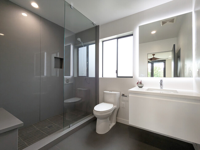 Modern european style shower, quartz shower walls, back lit mirrors, wall hung cabinets - 1136 18th St