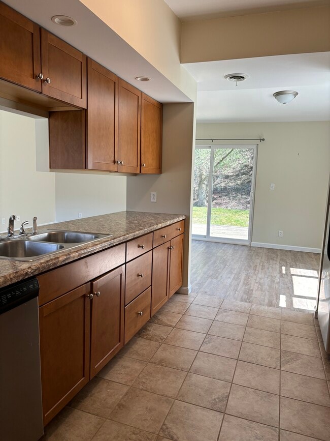 Tile floor in kitchen. New stainless appliances. - 102 Maple Ridge Dr