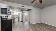 Located at 4815 E Thomas Rd in Phoenix, AZ, this one-bedroom, one-bathroom unit offers a well-designed, efficient layout across a single floor. The open-concept kitchen and living area forms the heart of the space, featuring wood-look luxury vinyl flooring that flows throughout. The kitchen is outfitted with stainless steel appliances — including a refrigerator, electric range, and over-the-range microwave — complemented by white shaker cabinetry, a subway tile backsplash, and a stainless steel sink. A ceiling fan overhead keeps the living area comfortable year-round. Natural light filters in through multiple windows fitted with blinds, brightening the neutral gray-toned walls throughout. The bedroom is a cozy, well-proportioned retreat, complete with its own ceiling fan, a window for natural light, and direct access to a dedicated closet with built-in shelving. The bathroom is clean and functional, featuring a combined tub and shower unit alongside a toilet and towel bar. Textured ceilings add a classic finish to every room. The thoughtful layout maximizes every square foot, making this a practical and comfortable home situated in a convenient Phoenix location.