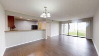 This 740-square-foot residence in Covington, Kentucky, offers a well-designed living space on a single floor. The home features an open-concept layout, combining the kitchen and living room for a spacious feel. Large sliding glass doors in the living area flood the space with natural light and provide access to an outdoor patio, extending the living space.

The kitchen is equipped with modern appliances, including a microwave and refrigerator. Rich wood cabinetry contrasts nicely with light-colored countertops and tile flooring. A convenient breakfast bar separates the kitchen from the living area, offering additional dining space.

The bedroom, measuring 260 square feet, is generously sized and features the same warm wood flooring found throughout the main living areas. The bathroom is well-appointed with a vanity, toilet, and shower/tub combination, finished with neutral-toned tiles.

Throughout the home, neutral wall colors and ample windows create a bright, airy atmosphere. The property's exterior features a low-maintenance design with a tiled facade and a grassy area, perfect for outdoor relaxation or gardening enthusiasts.