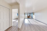 Located at 1321 Marshall St in Redwood City, California, this one-bedroom, one-bathroom unit offers a well-organized and efficiently designed layout across a single floor. Light-toned hardwood-style flooring runs throughout the home, lending a clean, cohesive look to every room.

The living area is bright and open, benefiting from large floor-to-ceiling sliding glass doors that lead to a private balcony, filling the space with abundant natural light and providing outdoor views of the surrounding neighborhood. The kitchen features white cabinetry, a countertop with an integrated sink, and includes a full-size refrigerator, all accented by a wall-mounted light fixture that adds a warm touch.

The generously sized primary bedroom is bathed in natural light through a wide bank of windows that frame city views, creating an airy and inviting atmosphere. A dedicated walk-in closet with built-in shelving provides ample and well-organized storage. The bathroom is clean and functional, equipped with a full tub-shower combo set against white tile surround. The overall ambiance of the unit is bright, minimalist, and move-in ready, offering comfortable urban living in the heart of Redwood City.