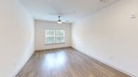 Located at 601 McCaw Bridge Street, Unit 304 in Raleigh, NC, this one-bedroom, one-bathroom residence offers a well-designed single-level layout with a thoughtful mix of comfort and modern finishes. The open kitchen and living area serves as the heart of the home, showcasing tall white shaker cabinetry, granite countertops, a subway tile backsplash, and a full suite of stainless steel appliances including a refrigerator, electric range, microwave, and dishwasher. A kitchen island provides additional prep and dining space, while warm hardwood-style flooring ties the area together seamlessly. The spacious bedroom features plush carpeting, a ceiling fan, and large windows with blinds that invite natural light and offer views of surrounding greenery. A dedicated closet provides ample storage. The full bathroom is finished with granite countertops, a white vanity, wood-look tile flooring, and a tub-shower combination. Practicality is further enhanced by a dedicated laundry room equipped with a full-size Whirlpool washer and dryer, complete with overhead wire shelving. Neutral tones and clean lines throughout create a bright, inviting atmosphere well-suited for everyday living in Raleigh.