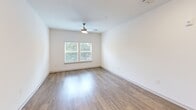 Located at 601 McCaw Bridge Street, Unit 304 in Raleigh, NC, this one-bedroom, one-bathroom residence offers a well-designed single-level layout with a thoughtful mix of comfort and modern finishes. The open kitchen and living area serves as the heart of the home, showcasing tall white shaker cabinetry, granite countertops, a subway tile backsplash, and a full suite of stainless steel appliances including a refrigerator, electric range, microwave, and dishwasher. A kitchen island provides additional prep and dining space, while warm hardwood-style flooring ties the area together seamlessly. The spacious bedroom features plush carpeting, a ceiling fan, and large windows with blinds that invite natural light and offer views of surrounding greenery. A dedicated closet provides ample storage. The full bathroom is finished with granite countertops, a white vanity, wood-look tile flooring, and a tub-shower combination. Practicality is further enhanced by a dedicated laundry room equipped with a full-size Whirlpool washer and dryer, complete with overhead wire shelving. Neutral tones and clean lines throughout create a bright, inviting atmosphere well-suited for everyday living in Raleigh.