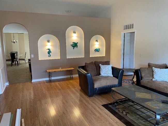 Living Room/Sitting Room as you enter the front door. Master bed/bath through arch on right. - 6040 Ridge Lake Cir