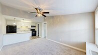Located at 425 E 19th St in Panama City, FL, this one-bedroom, one-bathroom unit offers a thoughtfully arranged single-floor layout. The open-concept living, dining, and kitchen area forms the heart of the home, featuring soft carpet underfoot in the living space and durable tile flooring throughout the kitchen. A ceiling fan with integrated lighting anchors the living area, adding both comfort and function.

The kitchen is well-appointed with crisp white cabinetry, granite countertops, a black appliance suite including a refrigerator and electric range, and elegant pendant lighting overhead. A peninsula counter provides additional prep space and naturally delineates the kitchen from the living and dining area.

The bedroom is a comfortable, carpeted retreat with a generous closet featuring bifold doors and a window that brings in natural light. Two closets throughout the unit provide ample storage. The bathroom continues the consistent design language with granite countertops, a white vanity with brushed nickel hardware, and a full tub-shower combination. The dedicated laundry room adds everyday convenience. Neutral gray tones throughout create a clean, cohesive ambiance.