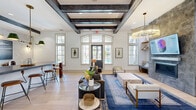 Located at 2024 Barr Road in Concord, NC, this single-floor amenity center at Coddle Creek delivers a well-appointed community hub spanning a generous footprint. The main clubhouse lounge immediately impresses with soaring ceilings adorned by striking dark wood beam detailing, wide-plank light hardwood flooring, and an abundance of natural light streaming through large arched and grid-pane windows. Stylish seating areas, a bar-height counter, and a branded feature wall create a welcoming, upscale atmosphere.

A secondary lounge area offers soft carpeting, comfortable seating, and glass partition walls that connect seamlessly to the broader space. The dual exercise rooms are comprehensively equipped with treadmills, stair climbers, cable machines, free weights, punching bags, resistance equipment, and floor exercise accessories — all beneath high ceilings with ceiling fans and mirrored walls to maximize the sense of space.

Outdoor covered patios feature stamped concrete flooring, stone-accented columns, ceiling fans, and plush lounge furniture ideal for relaxing. Additional outdoor amenities include a ping pong table, lounge chairs, dining seating, and landscaped grounds with pool access — all framed by views of the surrounding community.
