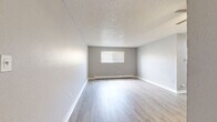 Located at 9440 Hoffman Way in Thornton, CO, this single-story, 2-bedroom, 1-bathroom home offers a well-organized layout connecting all living spaces through a central hallway. The living room is a bright, open space featuring light-wood luxury vinyl plank flooring, a textured ceiling, a baseboard heating unit, and a window fitted with blinds that allows natural light to fill the room. The galley-style kitchen is thoughtfully appointed with white shaker cabinetry, granite-look countertops, a mosaic tile backsplash, a stainless steel sink, and stainless steel appliances including a refrigerator, range, and dishwasher — all set atop matching light-wood LVP flooring. Both bedrooms are carpeted in a warm neutral tone and include ceiling fans, baseboard heating, windows with blinds, and mirrored sliding closet doors for convenient storage. The primary bedroom offers a comfortable footprint well-suited for a standard bedroom arrangement. The full bathroom features a clean white tub-shower combo, light-wood LVP flooring, and open shelving. With three closets distributed throughout and a neutral gray color palette across every room, this home presents a clean, move-in-ready interior ideal for everyday living.