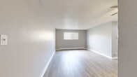 Located at 9440 Hoffman Way in Thornton, CO, this single-story, 2-bedroom, 1-bathroom home offers a well-organized layout connecting all living spaces through a central hallway. The living room is a bright, open space featuring light-wood luxury vinyl plank flooring, a textured ceiling, a baseboard heating unit, and a window fitted with blinds that allows natural light to fill the room. The galley-style kitchen is thoughtfully appointed with white shaker cabinetry, granite-look countertops, a mosaic tile backsplash, a stainless steel sink, and stainless steel appliances including a refrigerator, range, and dishwasher — all set atop matching light-wood LVP flooring. Both bedrooms are carpeted in a warm neutral tone and include ceiling fans, baseboard heating, windows with blinds, and mirrored sliding closet doors for convenient storage. The primary bedroom offers a comfortable footprint well-suited for a standard bedroom arrangement. The full bathroom features a clean white tub-shower combo, light-wood LVP flooring, and open shelving. With three closets distributed throughout and a neutral gray color palette across every room, this home presents a clean, move-in-ready interior ideal for everyday living.