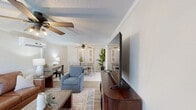 This well-appointed 2-bedroom, 1-bathroom home in Albany, Georgia offers a thoughtfully designed single-level layout that maximizes both comfort and functionality. Light-toned luxury vinyl plank flooring flows consistently throughout, tying together the living, dining, and kitchen areas with a cohesive, modern aesthetic. Crown molding and ceiling fans with decorative lighting fixtures are found throughout the home, adding character to each room.

The kitchen is a standout feature, showcasing crisp white shaker-style cabinetry with matte black hardware, white quartz countertops, a subway tile backsplash, and a full suite of stainless steel appliances including a range, microwave, and dishwasher. The adjacent hallway provides a natural transition to the bedrooms and bathroom.

The dining room comfortably accommodates a full-sized dining table and opens to the living area, making it ideal for entertaining. The primary bedroom includes a spacious closet and a wall-mounted climate control unit, while the second bedroom mirrors the home's clean, neutral design. The bathroom features a tub-shower combination with elegant marble-style tile surround and gold-toned fixtures. A dedicated laundry room with full-sized washer and dryer hookups adds everyday convenience to this move-in-ready home.