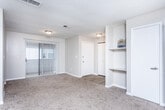 Located at 192 Earline Rd in Dothan, Alabama, this single-story unit offers a practical and comfortable layout designed for everyday living. The open living area is generously proportioned, finished with neutral-toned carpet and anchored by a ceiling fan with light fixture. A large window allows ample natural light to fill the space, while a sliding glass door provides access to the outdoors and adds additional brightness. The living area flows naturally toward the kitchen, which features a classic galley configuration with white cabinetry lining both sides, dark laminate countertops, a stainless steel sink, and a white electric range with overhead cabinetry. The flooring here transitions to wood-look planking, offering a clean and durable surface.

The bedrooms are carpeted and finished in warm neutral tones, each offering good proportions and natural light from windows. One bedroom features a ceiling fan and open shelving with closet access. Bathrooms are fitted with wood-look flooring, vanities with white cabinetry, and a tub-shower combination. Additional storage is provided throughout via closets with shelving. Textured ceilings and clean white trim are consistent throughout, giving the space a cohesive and tidy appearance overall.