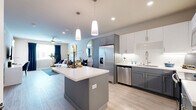 Located at 1501 Expo Pkwy in Sacramento, CA, this thoughtfully designed one-bedroom, one-bathroom residence offers a comfortable and stylish single-floor layout. The open-concept living, dining, and kitchen area creates a seamless flow throughout the main living space, anchored by light wood-look flooring and neutral tones that maximize brightness.

The kitchen is a standout feature, showcasing two-tone cabinetry with gray lower cabinets and white uppers, quartz countertops, a tile backsplash with under-cabinet lighting, and a full suite of stainless steel appliances including a refrigerator with ice maker, dishwasher, range, and microwave. A center island with pendant lighting above serves as both a prep area and casual dining spot.

The living room is bright and airy, benefiting from natural light through large windows dressed with navy curtains, complemented by a ceiling fan overhead. The dining area connects gracefully to the kitchen via a decorative round mirror accent wall.

The primary bedroom offers a generous, carpeted retreat with a ceiling fan, large window, and two closets for ample storage. The space is complete with a full bathroom and a private balcony, ideal for enjoying outdoor air. This residence combines modern finishes with a functional layout in a prime Sacramento location.