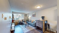 Located at 914 W Lake St in Fort Collins, Colorado, this single-floor unit offers a thoughtfully arranged layout that maximizes comfort and functionality. The living area serves as the heart of the space, featuring durable wood-style flooring, a textured ceiling, and a large window that invites natural light and offers views of the surrounding greenery. A wall-mounted air conditioning unit ensures year-round comfort, while a baseboard heating system adds warmth during cooler months. The living room provides ample space for seating and includes a dedicated area suitable for a desk or workstation, making it practical for everyday living.

The kitchen is efficiently designed with a galley-style layout, offering white upper cabinetry, gray lower cabinets, dark countertops, and a full suite of black appliances including a refrigerator, electric range, and dishwasher. Wood-style flooring continues throughout, maintaining a cohesive aesthetic.

The bedroom is a calm, carpeted retreat with warm neutral tones, a textured ceiling, and a window that allows natural light to filter in. The bathroom features a clean, white-tiled tub and shower combination with chrome fixtures, providing a simple and functional design.

Overall, the space presents a clean, modern aesthetic with a neutral color palette and practical finishes, ideally situated in the vibrant West Lake Street corridor of Fort Collins.