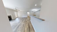 Located in Montgomery, Alabama, this single-floor residence offers a well-designed layout with a variety of updated finishes throughout. The open living area is anchored by a tile-surround wood-burning fireplace framed by a classic white mantel, flanked by windows and a full-glass exterior door that floods the space with natural light. A ceiling fan overhead and wood-style laminate flooring underfoot add both comfort and a clean, contemporary feel.

Adjacent to the living area, the dining space features crown molding and an elegant chandelier, creating a refined yet approachable setting. A half-wall with granite-style countertop separates the entry from the main living area, providing a functional and stylish transition. The galley-style kitchen is outfitted with white cabinetry, light countertops, a stainless steel sink, and black appliances including a range, microwave, and refrigerator, alongside wood-style flooring for easy maintenance.

The bedroom is generously proportioned and features full-wall mirrored closets, carpeted flooring, a ceiling fan, and a glass-panel door leading outside. The bathroom includes a wide vanity with a large mirror, ample lighting, and wood-style flooring. Crown molding and neutral gray tones are carried throughout, lending the entire space a cohesive and polished character.