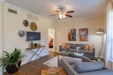 Located at 15330 Bammel North Houston Rd in Houston, TX, this single-floor residence combines comfort and thoughtful design throughout its well-organized layout. The living room is a welcoming centerpiece, featuring rich hardwood-style flooring, crown molding, and a ceiling fan overhead. Natural light pours in through large windows dressed with sheer white curtains and horizontal blinds, creating a bright and airy atmosphere. A glass-top coffee table and comfortable seating complete the space.

Adjacent to the living area, a cozy dining nook accommodates intimate gatherings, highlighted by a large rustic wood-framed mirror that adds depth and character to the room. Sheer curtains frame the nearby window, enhancing the warm, inviting feel.

The kitchen is efficiently designed in an L-shaped configuration, offering gray cabinetry, granite-look countertops, black appliances, and hardwood-style flooring that flows seamlessly from the main living areas. A window above the sink brings in natural light.

The bedroom is a tranquil retreat with plush carpet, a ceiling fan, and a walk-in closet with wire shelving. Natural light filters through sheer-curtained windows, adding to the room's serene ambiance.

The bathroom features a tub-shower combination, a vanity with gray cabinetry and granite-look countertops, and hardwood-style flooring, completing this well-rounded Houston residence.