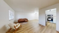 Located at 1902 Jefferson St in Norman, Oklahoma, this single-story home offers three bedrooms and two bathrooms across a well-utilized floor plan. The open living area greets you with light wood-look flooring, crisp white walls, and a ceiling fixture that adds a touch of warmth. Natural light filters through window blinds, creating a bright and welcoming atmosphere throughout.

The kitchen is a standout feature, equipped with stainless steel appliances — including a refrigerator, range, microwave, and dishwasher — paired with white shaker-style cabinetry, a subway tile backsplash, and light countertops. The light flooring carries seamlessly from the living area into the kitchen, reinforcing a cohesive aesthetic.

The primary bedroom is a comfortable retreat, offering two closets, a window with natural light, and wood-look flooring. The additional bedrooms are similarly finished, with clean walls, light flooring, and built-in closet space. Ceiling fans in the bedrooms add practical comfort.

Both bathrooms are clean and functional. One features a white vanity with a black-hardware faucet, a mirror, and a shower-tub combination. The second bathroom echoes this design with a vanity, mirror, and modern black fixtures accented by bright overhead lighting. The hallway connects all rooms efficiently, making for a practical and comfortable layout throughout.