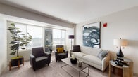 Located at 160 Pleasant St in Malden, MA, this contemporary single-floor residence offers a thoughtfully designed layout with stylish finishes throughout. The living room serves as an inviting centerpiece, featuring large windows that flood the space with natural light and frame open views of the surrounding cityscape. Neutral-toned carpeting and clean wall finishes create a calm, modern ambiance complemented by curated décor.

The galley-style kitchen is efficiently organized, featuring light wood cabinetry, granite-style countertops, hardwood flooring, and a full suite of stainless steel appliances including a refrigerator, range, and dishwasher. The bedrooms are generously proportioned, with the primary bedroom boasting expansive corner windows that offer panoramic outdoor views and plush carpeting underfoot. A secondary bedroom functions flexibly as a home office, bathed in natural light from dual windows overlooking the exterior.

Two full bathrooms feature light wood vanities with granite-style countertops, large mirrors, and windows providing ventilation and natural light. Additional highlights include a dedicated study or flex room with closet storage. The overall design balances comfort and functionality, making this a well-rounded residence in a modern building setting.