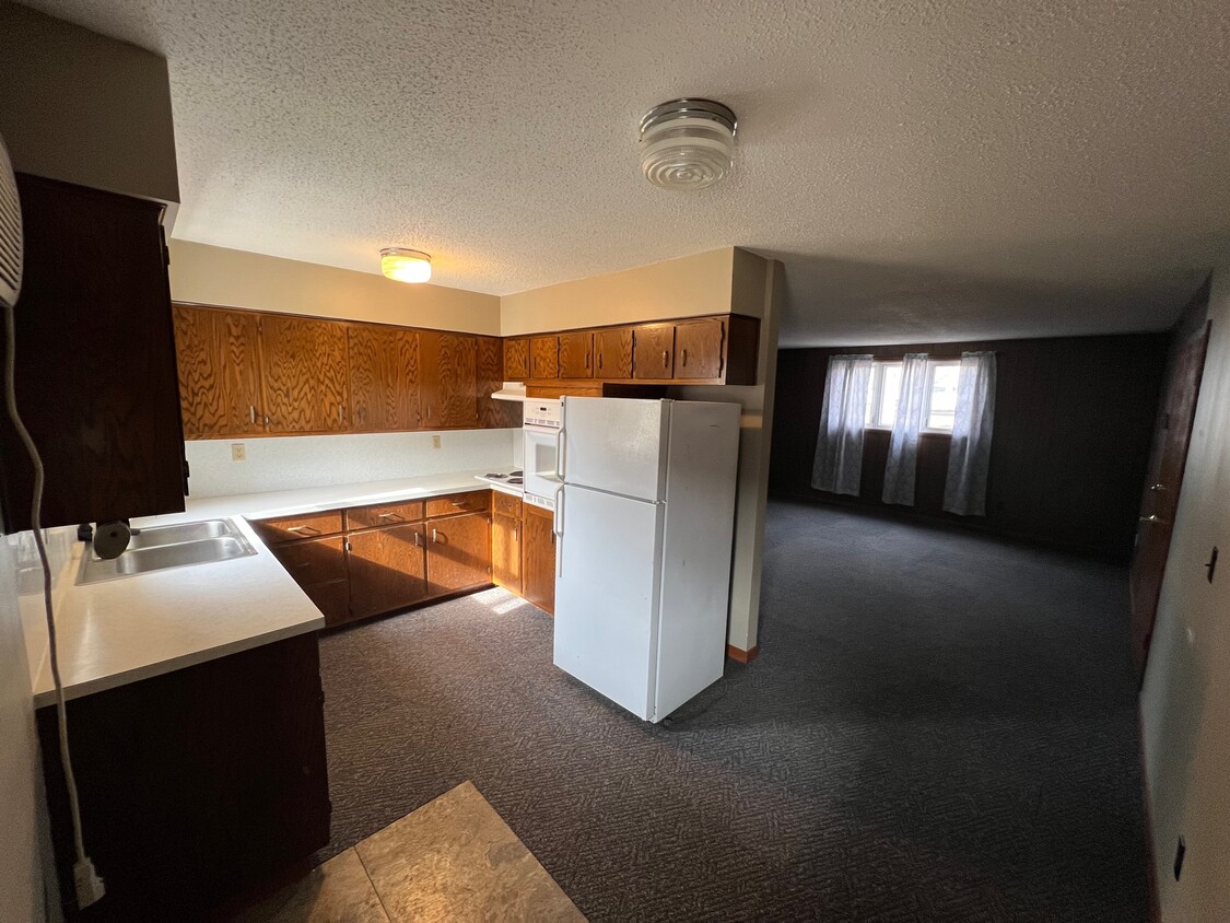 Kitchen has electric stovetop, wall oven, full refrigerator and a rear entry/exit to the apartment! - 500 Sunrise Ln