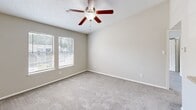 Located at Chase Wellesley Court in Richmond, Virginia, this two-bedroom, one-bathroom residence offers a well-organized single-floor layout designed for comfortable everyday living. The kitchen is efficiently arranged with dark espresso-toned cabinetry, light stone-look countertops, and a full suite of stainless steel appliances including a refrigerator, electric range, and over-the-range microwave. Wood-look flooring grounds the kitchen area, adding warmth and durability to the space. The open layout connects the kitchen to the main living area, as seen in the dollhouse view, creating a practical flow throughout the home. Both bedrooms feature plush wall-to-wall carpeting and neutral gray walls that lend a calm, versatile backdrop. The primary bedroom is generously proportioned, with natural light streaming in through double windows fitted with horizontal blinds, and a ceiling fan that enhances comfort year-round. The second bedroom also benefits from natural light and includes convenient access to both a closet and the shared bathroom. The bathroom is clean and functional, featuring a full tub-shower combination with white tile surround and chrome fixtures. A dedicated closet provides additional storage. The textured ceilings throughout and consistent neutral palette give the home a cohesive, move-in-ready appeal.