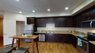 Located at 1500 Cherry St in Placentia, CA, this single-story residence offers a thoughtfully designed layout with a cohesive blend of comfort and functionality. The kitchen is a standout feature, showcasing rich dark-espresso cabinetry extending from floor to ceiling, granite-look countertops, stainless steel appliances including a refrigerator and dishwasher, and warm wood-look flooring that carries throughout the common areas. Recessed lighting illuminates the kitchen, creating a bright and practical workspace.

The bedrooms are carpeted for comfort and benefit from natural light provided by windows with blinds. Each room offers a neutral color palette, clean lines, and closet storage. The hallways and open areas connect the space efficiently, with recessed lighting maintaining a clean, modern aesthetic.

Two bathrooms serve the residence — one features a walk-in glass-enclosed shower with dark cabinetry and granite countertops, while the second includes a full tub and shower combination. Both bathrooms continue the consistent design language found throughout the space.

A dedicated in-unit laundry area accommodates a full-sized washer and dryer side by side, adding a layer of everyday convenience. Overall, the space presents a clean, move-in ready interior with consistent finishes throughout.