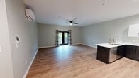 Located at 750 Lakeview St in Bristol, Tennessee, this well-appointed single-story home offers three bedrooms and three bathrooms across a comfortable, efficiently designed floor plan. Warm hardwood-style flooring flows consistently throughout, tying the living spaces together with a cohesive, modern aesthetic.

The open-concept living room is bright and inviting, highlighted by a ceiling fan, a wall-mounted mini-split system, and a set of French doors with classic buffalo-check drapes that open to an outdoor deck, bringing in natural light and outdoor views.

The kitchen is a standout feature, boasting striking white quartz countertops with elegant veining, a bold two-tone design with dark lower cabinetry and white upper shaker-style cabinets, a gold-finish faucet, stainless steel appliances including a refrigerator, range, and microwave, and a peninsula that provides additional counter space and seating potential.

The primary bedroom is generously sized, equipped with its own mini-split unit and a walk-in closet. The additional bedrooms offer well-proportioned spaces with hardwood-style flooring, natural light, and closet storage. The bathrooms continue the modern design language, featuring light blue-gray walls, wood-look flooring, and contemporary vanities with marble-style countertops.