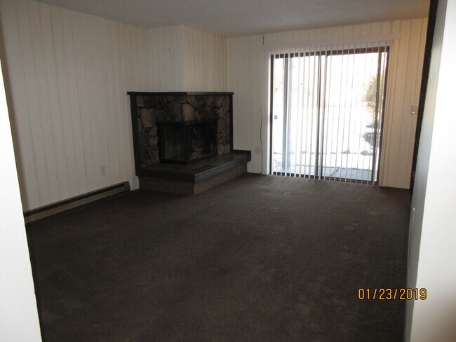 living room with slider, fireplace - 8910 E Broadway Ave