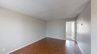 Located at 1415 W Freddy Gonzalez Dr in Edinburg, TX, this single-story, one-bedroom, one-bathroom unit offers a practical and comfortable layout across a compact but well-utilized floor plan. The living area greets you with warm wood-look flooring, neutral gray walls, and multiple windows that allow natural light to fill the space. A ceiling fan overhead and a thermostat on the wall add to everyday functionality. The open feel of the living room is enhanced by its clean lines and understated design. The galley-style kitchen is efficiently arranged with white cabinetry, light countertops, a stainless steel sink, and white appliances including a refrigerator and stove. A separate closet door at the end of the kitchen provides additional storage. The bedroom features plush carpet flooring, a ceiling fan with light fixture, and a generous window with blinds that invites natural light while maintaining privacy. A dedicated closet completes the bedroom. The bathroom includes a full-size combination tub and shower, a toilet, and wood-look flooring that ties back to the rest of the unit. Throughout, the space maintains a clean, neutral palette that offers a move-in-ready foundation for personalization.