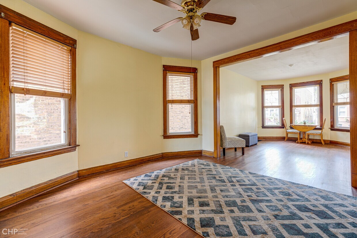 Large living room and dining room with refinished hardwood floors and fresh paint - 1833 N Harding Ave