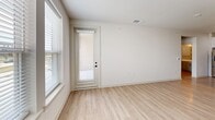 Located in Lafayette, Louisiana, this well-designed one-bedroom, one-bathroom unit offers a thoughtfully efficient layout across a single floor. Light-toned luxury vinyl plank flooring runs throughout, creating a clean, cohesive aesthetic in every room.

The open-concept kitchen and living area serves as the heart of the unit. The kitchen is outfitted with crisp white cabinetry extending to the ceiling, stainless steel appliances including a French door refrigerator, electric range, and built-in microwave, as well as a geometric tile backsplash and a generous light-colored countertop peninsula. Pendant lighting with sleek black fixtures adds a modern touch overhead.

The living area benefits from abundant natural light through large windows and a glass-panel door, with views of the surrounding neighborhood. A ceiling fan with a matte black finish is installed in the bedroom, which also features a window with exterior views and a dedicated closet equipped with built-in shelving for organized storage.

The bathroom is a standout space, featuring a tub and shower combination accented by elegant marble-style surround tile, complemented by built-in open shelving and light wood-look flooring. A dedicated laundry room with full-size washer and dryer hookups and wall-mounted drying racks adds practical convenience to this thoughtfully appointed home.