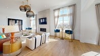 Located at 77 Exuma Way in Santa Rosa Beach, Florida, this single-floor space offers a well-appointed coastal-modern interior designed with both style and function in mind. Wide-plank hardwood floors run throughout, anchoring the open and airy layout that is flooded with natural light through oversized floor-to-ceiling windows dressed with sheer linen drapes.

The expansive living room is a standout, featuring soaring ceilings, shiplap wall accents, and a sleek floor-to-ceiling tiled fireplace with a mounted flat-screen television. Woven pendant light fixtures add warmth and texture, while elegant blue velvet accent chairs and a mix of contemporary furnishings complete the coastal aesthetic. A pool table and additional seating areas offer versatile use of the generous open floor plan.

A stylish kitchen area showcases dark navy cabinetry contrasted against a white subway tile backsplash and a bright white countertop island with bar seating. Dual statement pendant lights illuminate the space with a refined, modern touch.

The dedicated office features vibrant teal walls, built-in dual workstations with ample storage, and curated abstract artwork — creating an energizing yet focused environment. The entry welcomes visitors with black-framed glass double doors, shiplap walls, and an abundance of natural light, setting the tone for the bright, sophisticated space within.