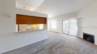 Located at 2864 Carpenter Rd in Ann Arbor, MI, this one-bedroom, one-bathroom residence offers a well-organized layout across a single floor. The open-concept living and dining area is carpeted throughout and anchored by a fireplace, creating a warm and inviting atmosphere. A large sliding glass door floods the space with natural light and provides direct access to a private balcony with outdoor views. The kitchen features a pass-through window with a warm wood accent panel, galley-style layout with ample upper cabinetry, laminate countertops, a double sink, and wood-look flooring, along with an adjacent pantry for additional storage. A separate dining room completes the main living area. The bedroom is generously sized with plush carpet, a large window, and a wood-paneled double closet. Additional closets throughout the unit provide substantial storage. The bathroom includes a full tub-shower combo with white tile surround, wood vanity with a white countertop, and wood-look flooring. Carpeted stairs with white railings lead to the upper level. The unit also includes in-unit laundry access, two hallways, and multiple closets, contributing to a practical and comfortable living experience.