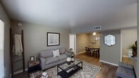 This 2-bedroom, 2-bathroom apartment in College Station, TX offers a thoughtfully arranged single-story floor plan designed for comfortable everyday living. The living room serves as the heart of the unit, featuring wood-look flooring, neutral gray walls, and a large window that fills the space with natural light. It flows seamlessly into a dedicated dining area, which is accented by a ceiling fan and a pass-through window connecting directly to the kitchen — a practical touch that enhances the open feel between spaces.

The kitchen is equipped with warm wood-toned cabinetry, granite-look countertops, a double stainless steel sink, and full appliances, providing ample storage and prep space along its galley-style layout.

Both bedrooms are comfortably sized, each featuring ceiling fans, wood-look flooring, and windows with exterior views. The rooms are finished with the same neutral gray palette that carries throughout the unit, creating a cohesive and calming atmosphere.

The two bathrooms are clean and functional, each featuring a wide vanity with a large mirror, bright overhead lighting, and a shower-tub combination. The overall design of this apartment prioritizes practicality and comfort, making it a well-rounded living space in the heart of College Station.